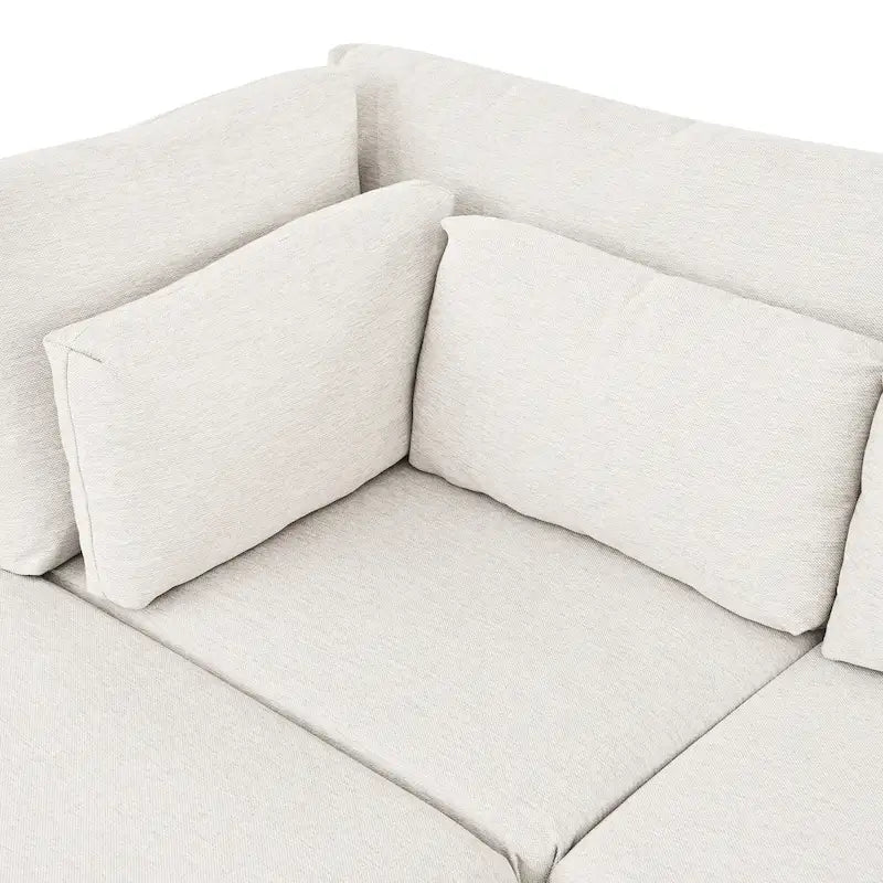 Sofá modular seccional con otomana y almohadas