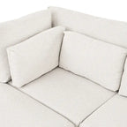 Sofá modular seccional con otomana y almohadas