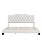Base de cama tapizada con plataforma, cabecero curvo tipo silla de montar y detalles de rombos capitoné